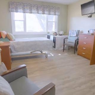 A well-lit and comfortable hospital room designed for patient care.