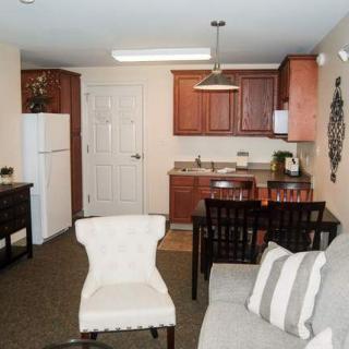 A compact apartment with an open kitchen and a cozy living area.