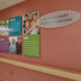 A hospital wall display featuring family and children-themed informational panels.