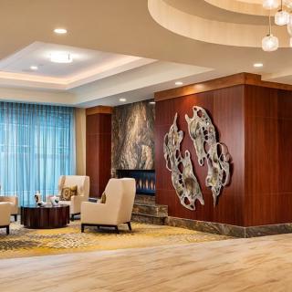 A modern hotel lobby featuring elegant seating and contemporary artwork.