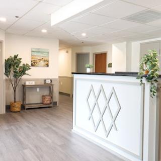 A bright and modern reception area featuring stylish design elements and greenery.