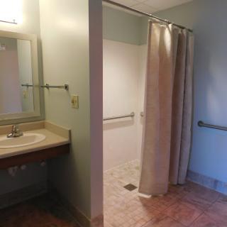 A clean and accessible bathroom featuring a shower and vanity.
