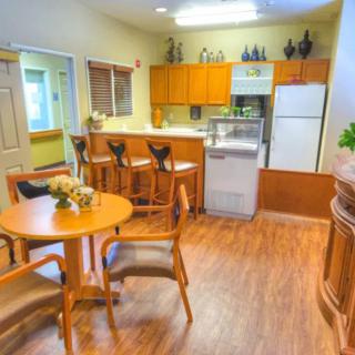 A cozy kitchen with a dining area featuring wooden furniture and modern appliances.