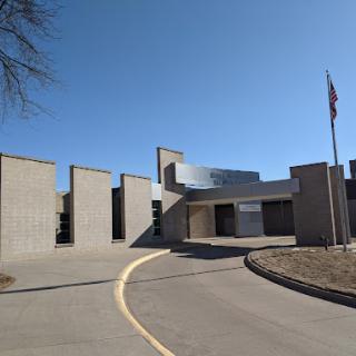A modern architectural structure set against a clear blue sky.