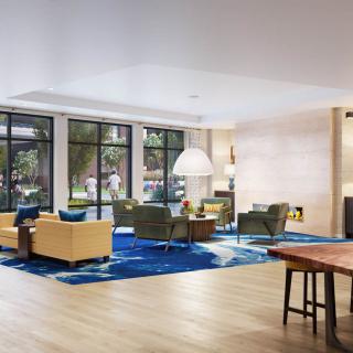 A modern lobby with comfortable seating and large windows.