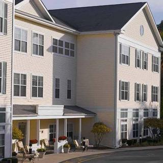 A multi-story residential building with a clean architectural design and numerous windows.