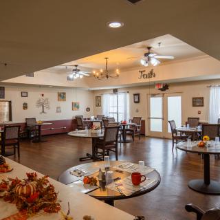 A cozy dining area with decorated tables and ample lighting.
