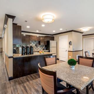 A modern kitchen and dining area with contemporary furnishings and appliances.
