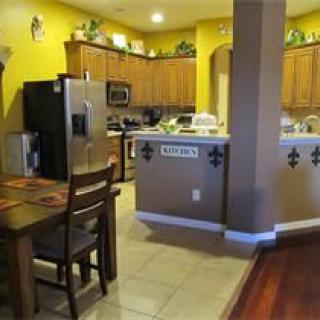 A cozy kitchen with wooden cabinets and a dining area.