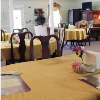 An empty dining room with tables set and ready for guests.