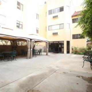 A residential courtyard with outdoor seating and canopies.