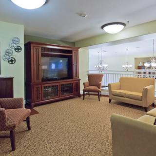 A modern living room with comfortable seating and a large television.