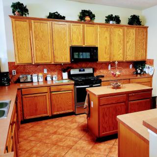A modern kitchen with wooden cabinets and a central island.