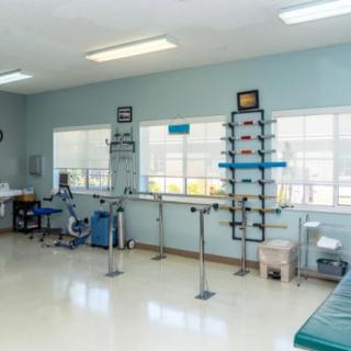 A well-equipped physical therapy and rehabilitation room featuring various exercise equipment.
