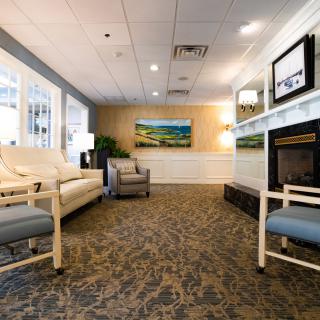 A modern lobby with comfortable seating, artwork, and a warm ambiance.
