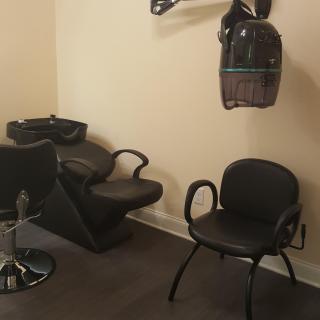 A cozy hair salon setup with a washing station and drying area.