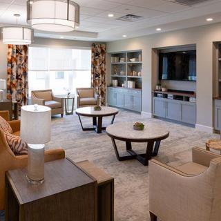 A modern living room with stylish furniture and decor, featuring comfortable seating and elegant lighting.