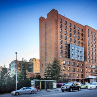 A modern hotel building situated in an urban environment, showcasing contemporary architecture.