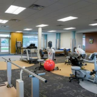 A well-equipped physical therapy and rehabilitation center with various exercise machines and equipment.
