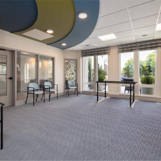 A modern, spacious interior with large windows and minimalistic furnishings.