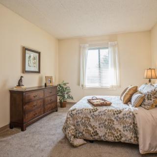 A cozy bedroom with elegant decor and natural light.