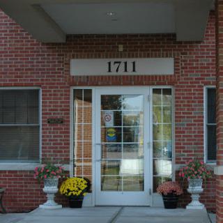 Entrance of a building with the number 1711 displayed above the door.