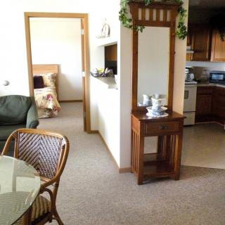 A cozy living space with a view into the bedroom and kitchen areas.