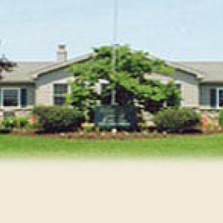 A residential house with a well-maintained garden and lawn.