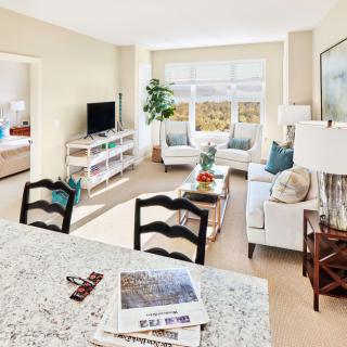 A bright and stylish living room with a comfortable sofa, television, and decor accents.
