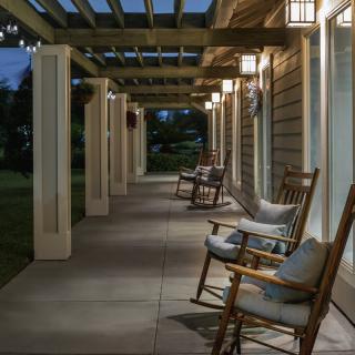 A welcoming porch with wooden rocking chairs and soft evening lighting.