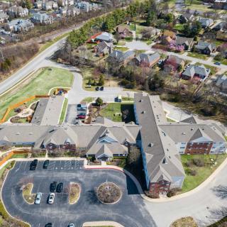 Aerial view of a suburban residential area with buildings and surrounding roads.