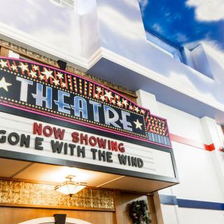 A theater marquee displaying 'Now Showing: Gone with the Wind'.
