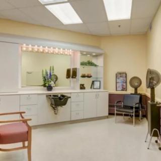 A well-organized salon interior with styling stations and hair dryers.