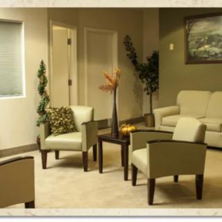 A cozy waiting room with comfortable seating and warm decor.