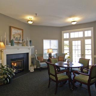 A cozy living room with a fireplace and comfortable seating arrangement.