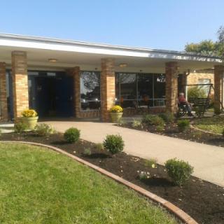 A well-maintained building with landscaped grounds on a sunny day.