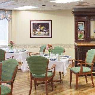 A cozy dining room with neatly arranged tables and chairs.