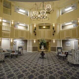 An elegant lobby featuring stylish furniture, a grand chandelier, and an inviting atmosphere.