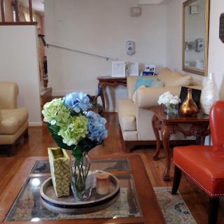 A cozy living room featuring elegant furniture and colorful floral decor.