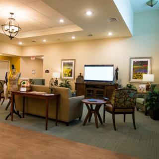 A cozy living room with comfortable seating and a large television.