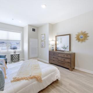 A modern and minimalist bedroom with bright lighting and stylish decor.