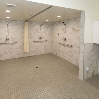 A modern tiled shower area with multiple showerheads and a clean design.