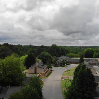 A serene aerial view of a suburban neighborhood under a cloudy sky.