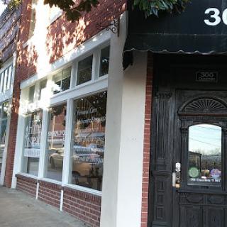 A charming brick storefront with large windows and a welcoming entrance.