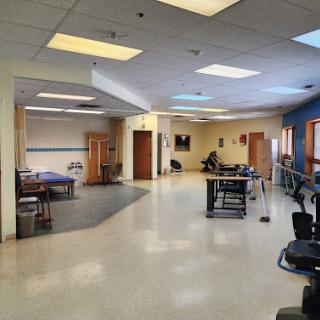 A spacious and well-lit therapy room designed for rehabilitation.