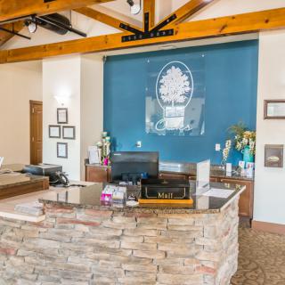 A welcoming office reception area with a stone desk and modern decor.