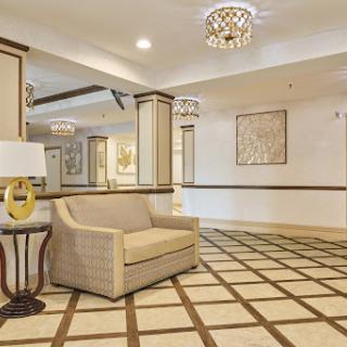 A stylish lobby area featuring a comfortable sofa and elegant lighting.