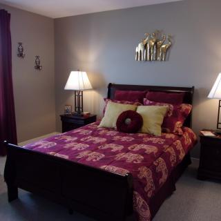 A cozy bedroom with elegant decor and lighting.