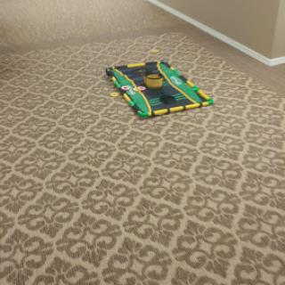 A colorful car mat laid out on the patterned carpet, perfect for playtime.