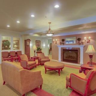 A cozy living room with comfortable seating and a fireplace.